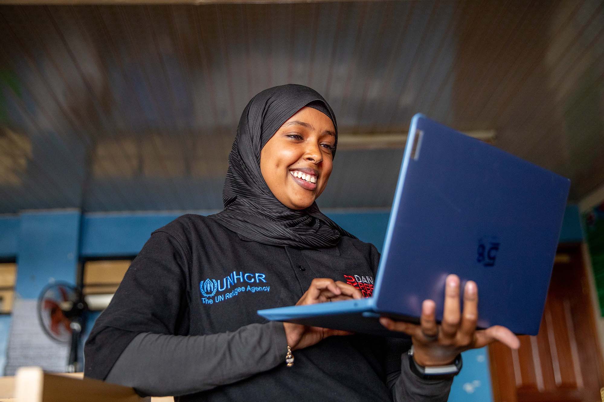 young woman holding laptop