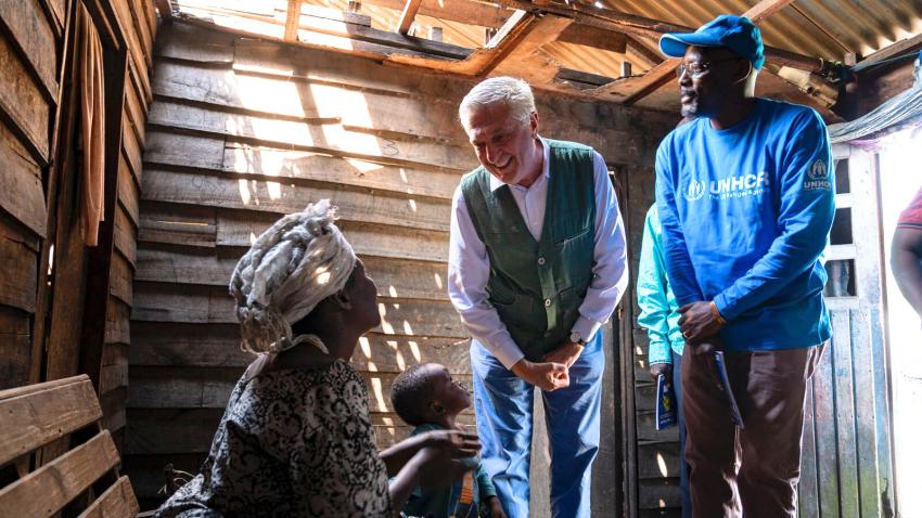 Grandi speaking to mother and child in a hut