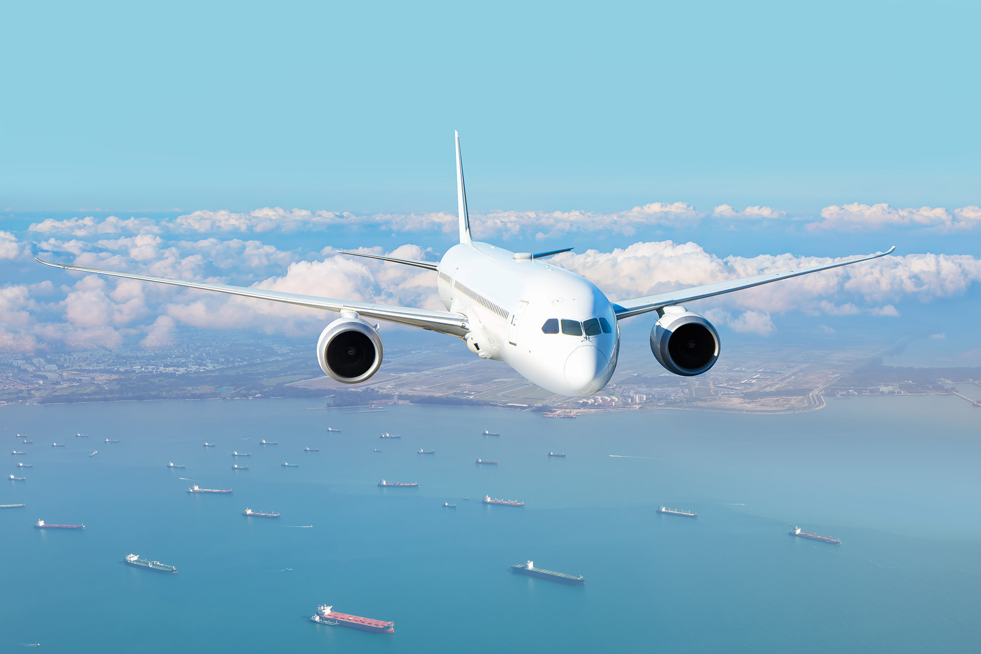 Passenger airplane flying over sea.