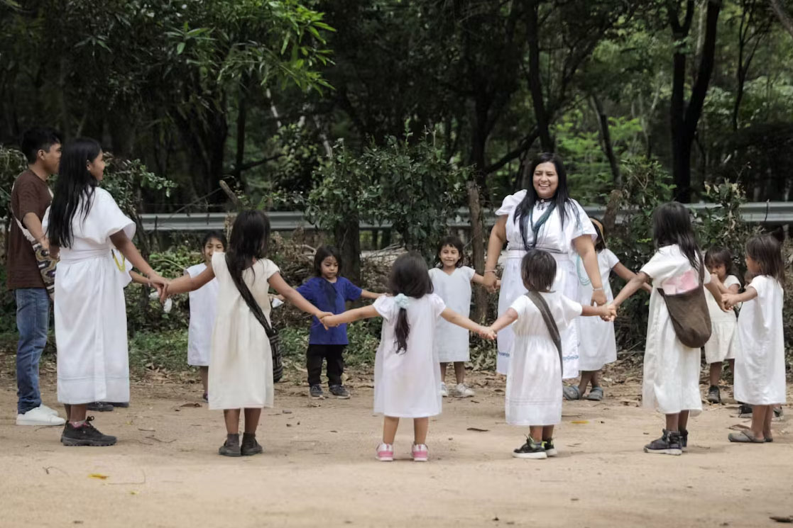 A group of workers with children in a playground.