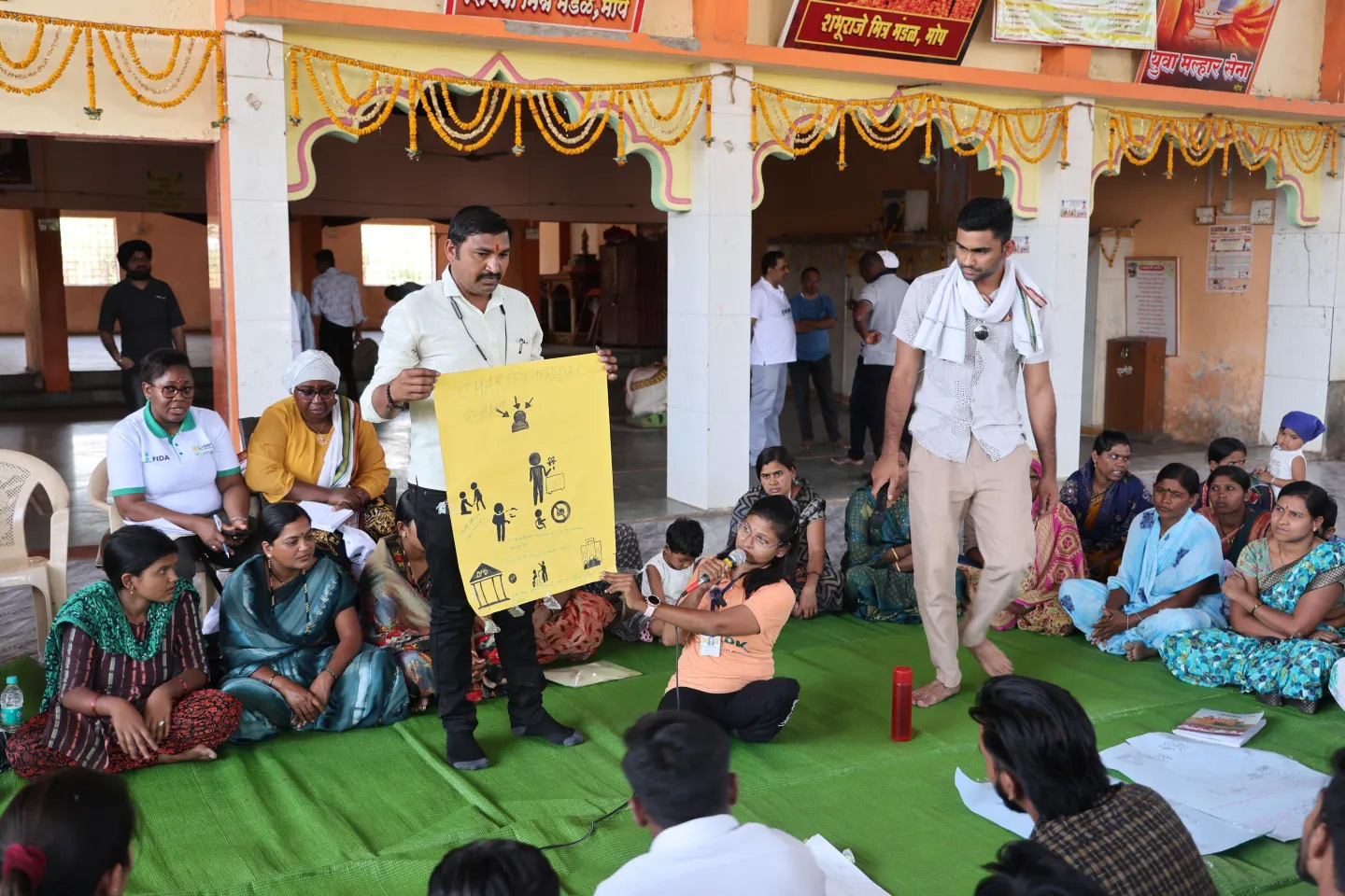 A man leading a community workshop on disabilities.