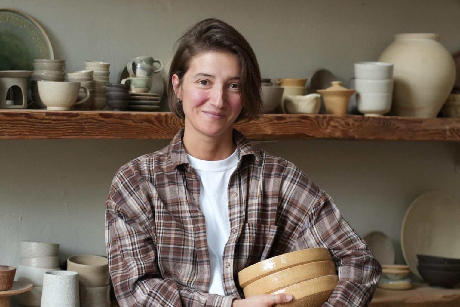Elvira Demerdzhi holding her clay artifacts.