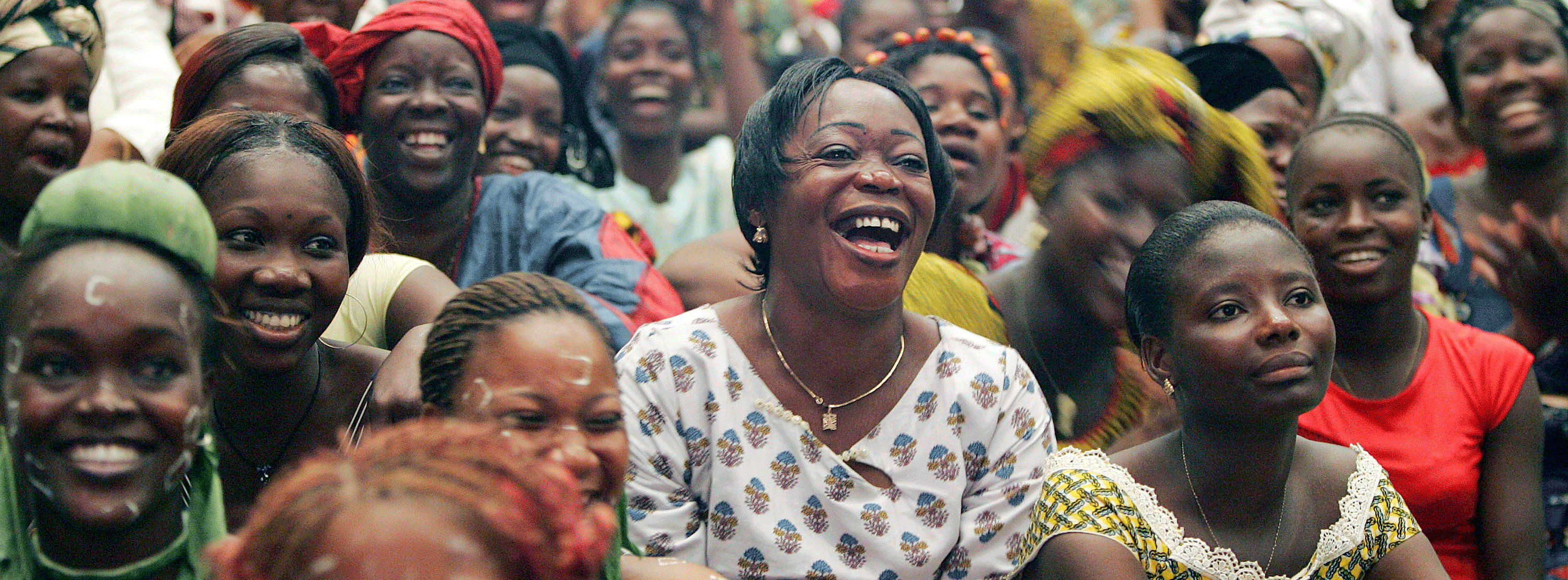 A crowd of women sitting down and laughing.&nbsp;