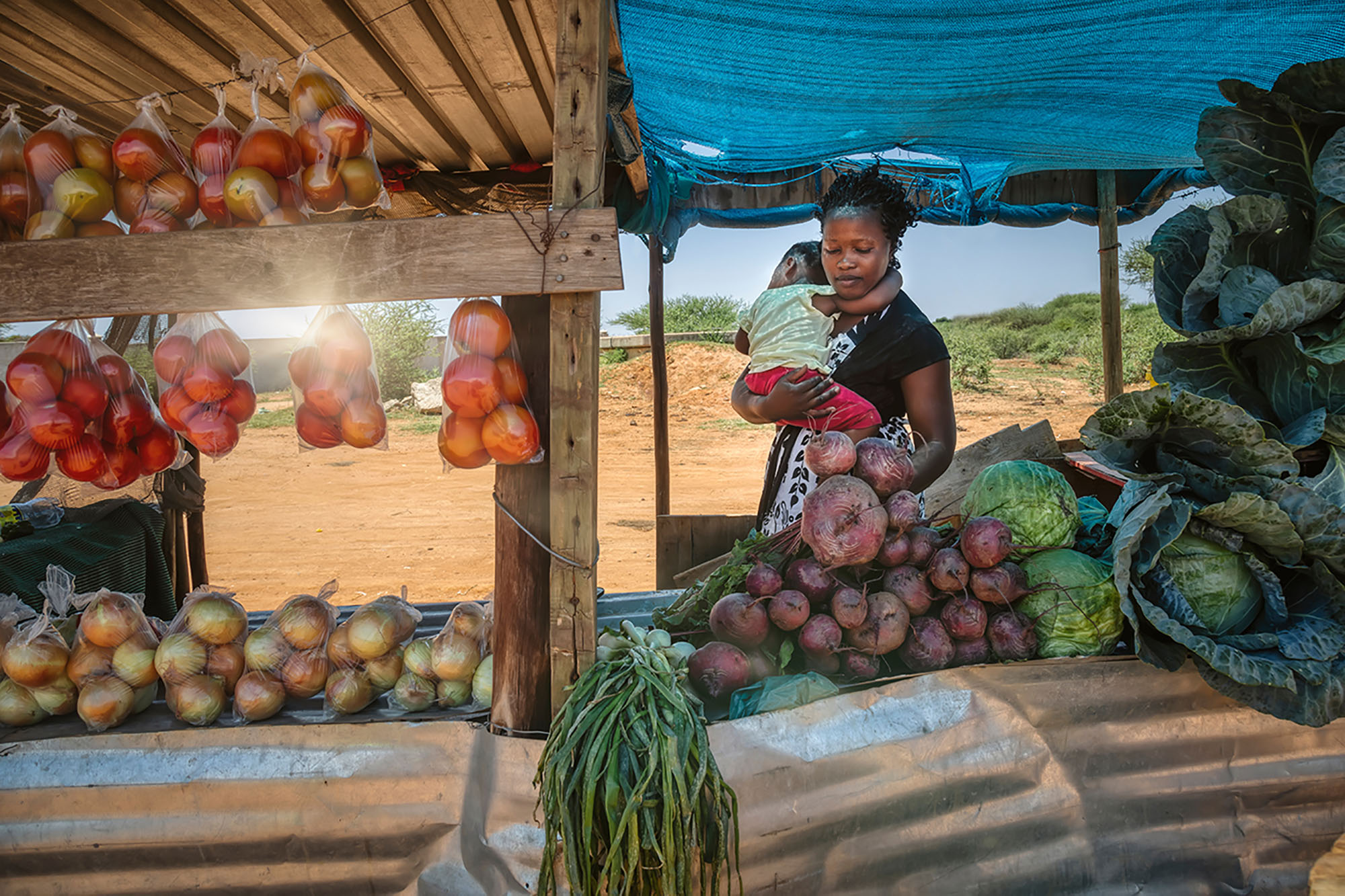 African street vendor with her child.